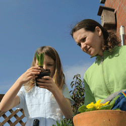 teacher helping student garden