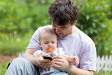 Father and baby with cellphone