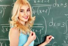 girl doing a math problem on the board