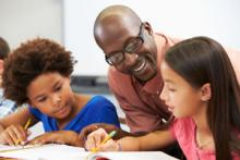 teacher working with students one on one